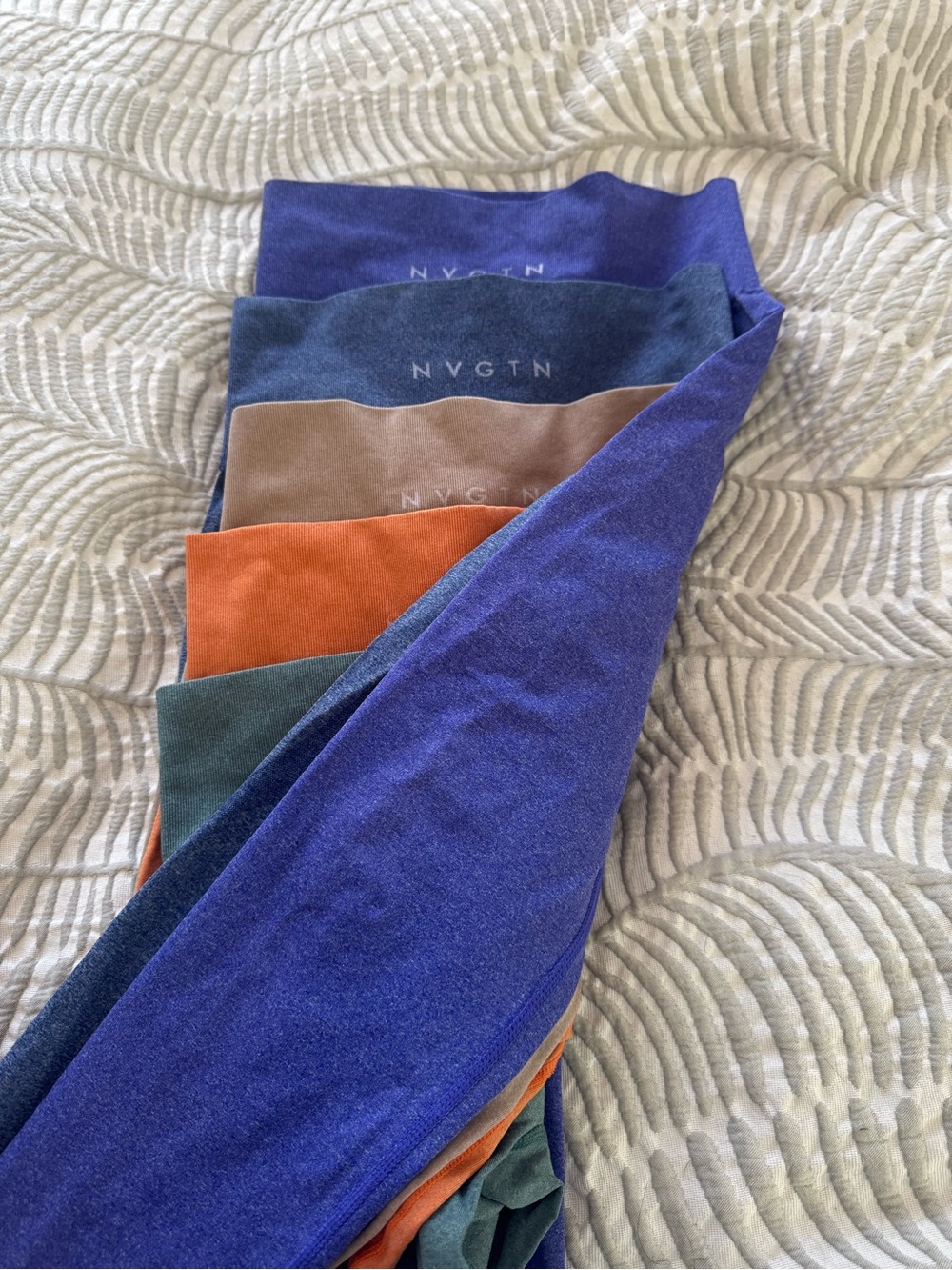 5 pairs of NVGTN Leggings — Blue, tan, Orange, purple, & Green